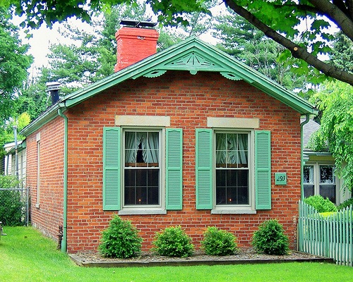 brick cottage with green trim