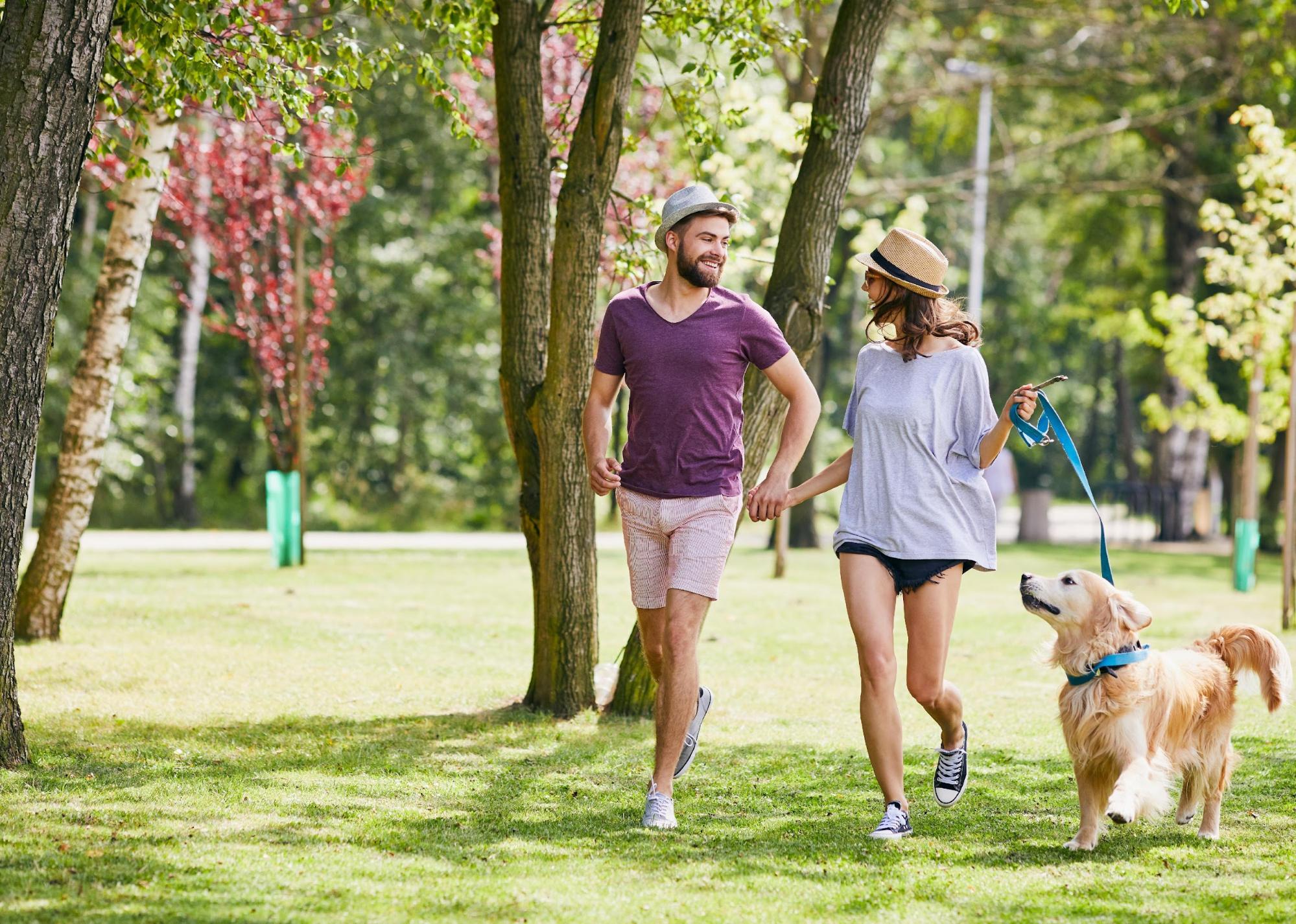 #23. Maplewood, Missouri Young couple running in the park with their dog.