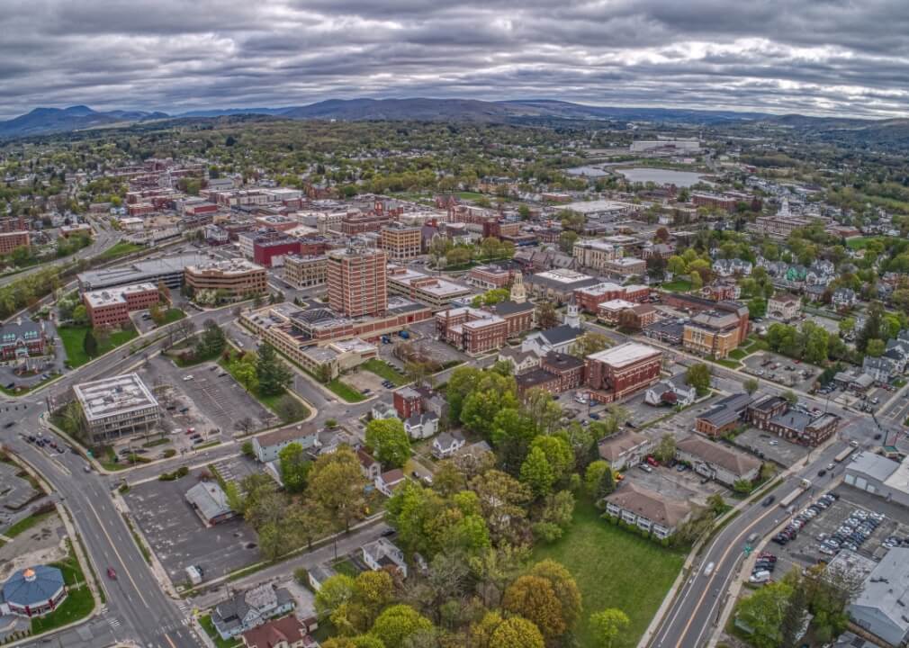 Aerial view of downtown Pittsfield, MA with mountains in the distance.