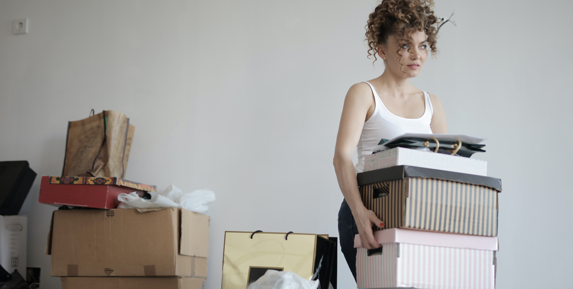 A frustrated woman carrying boxes