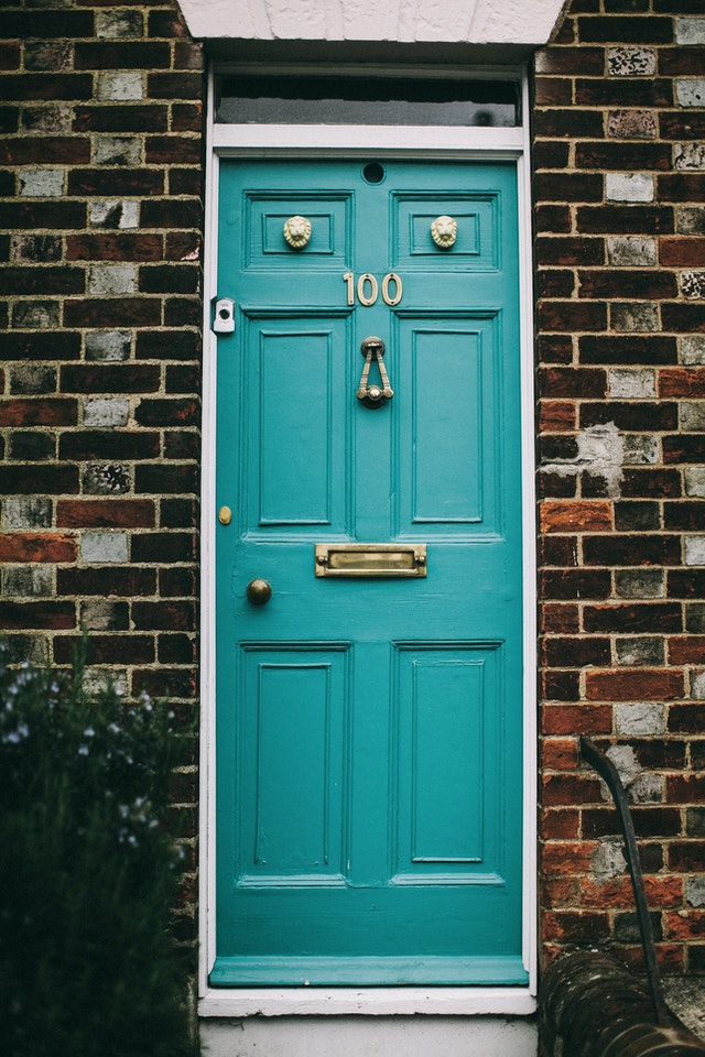 teal front door with number 100 address