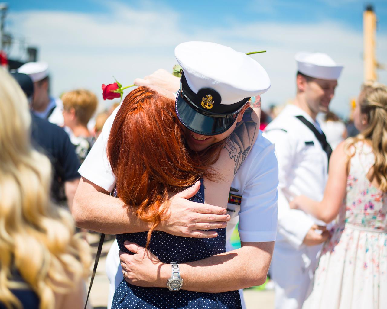 sailor hugging a woman