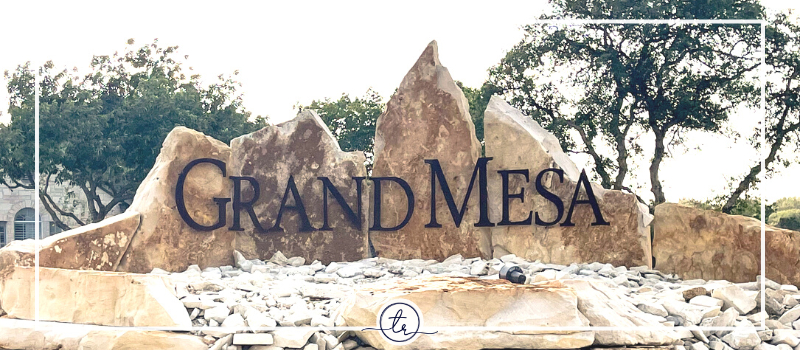 A neighborhood rock monument reading GRAND MESA