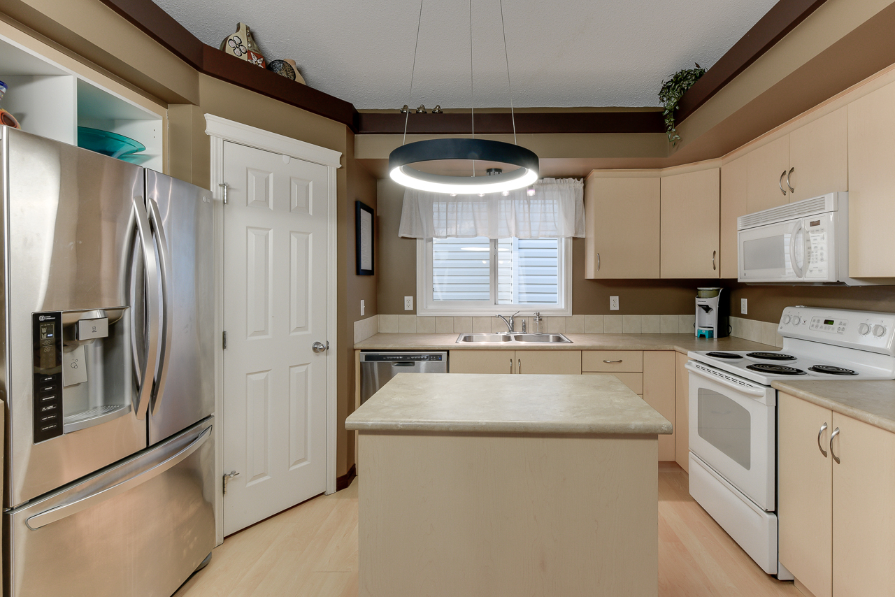 a kitchen with a sink and a refrigerator