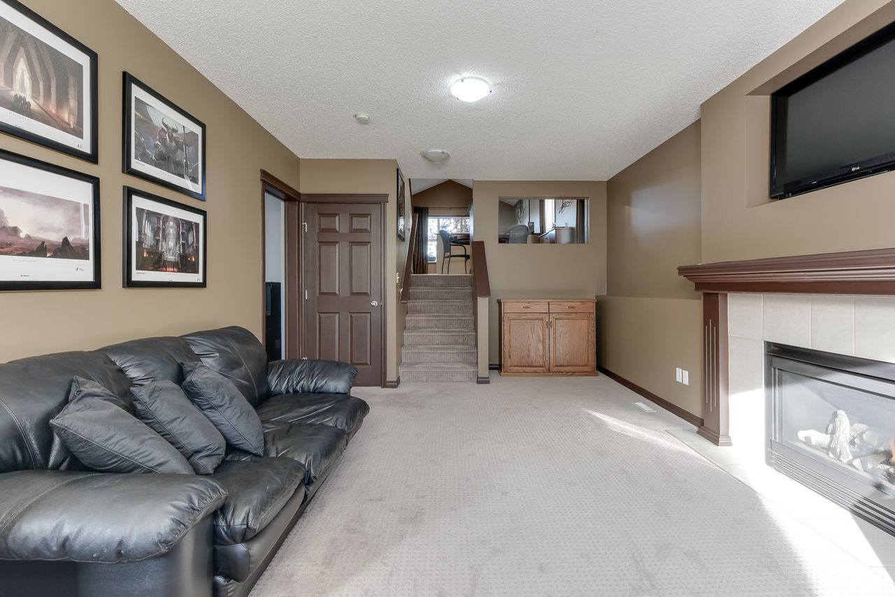 a living room filled with furniture and a flat screen tv