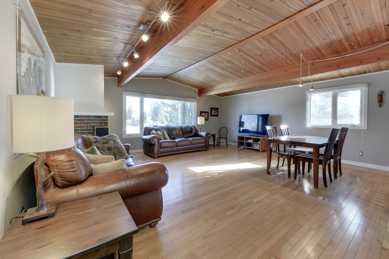 a living room filled with furniture on top of a hard wood floor