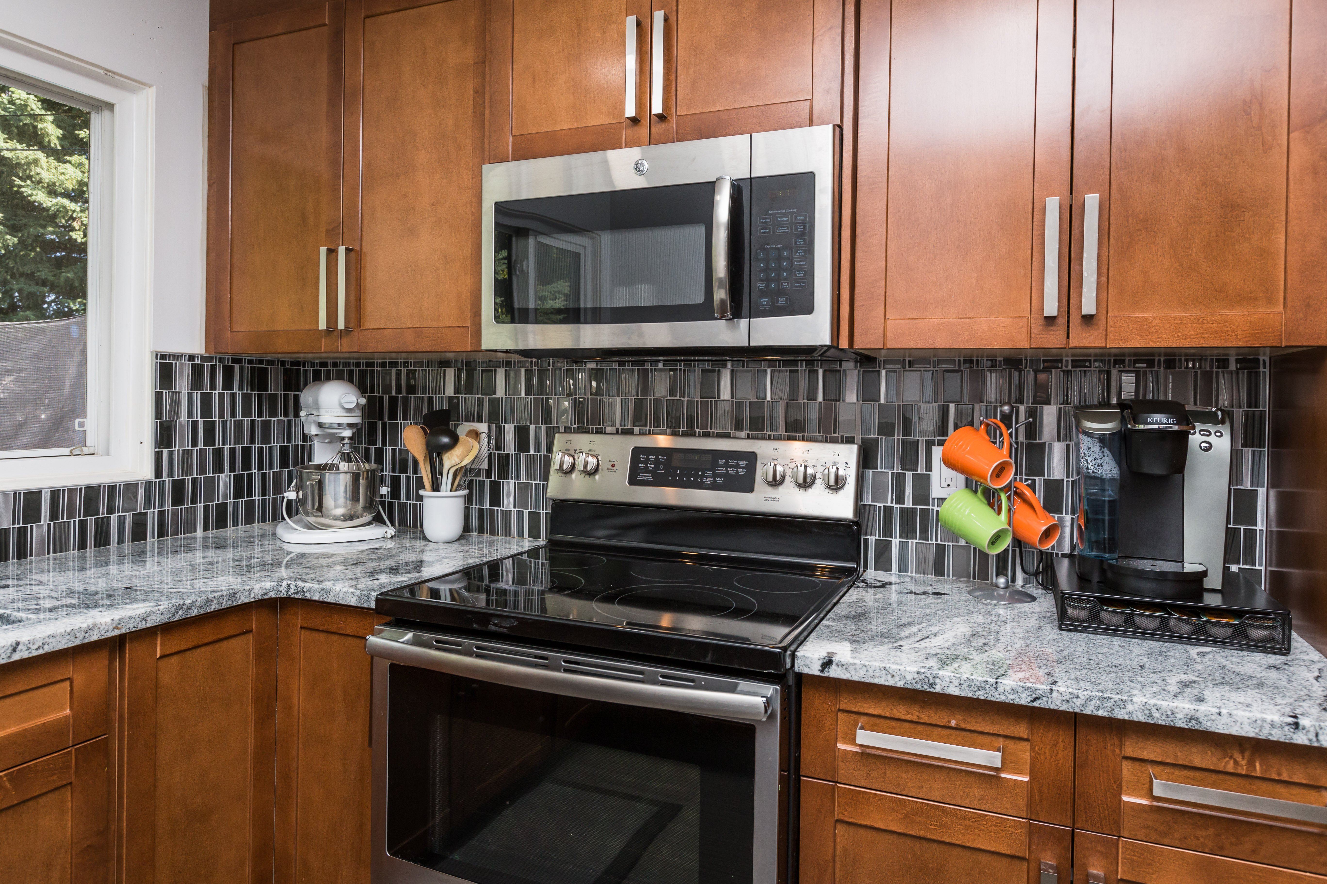 a kitchen with stainless steel appliances and wooden cabinets