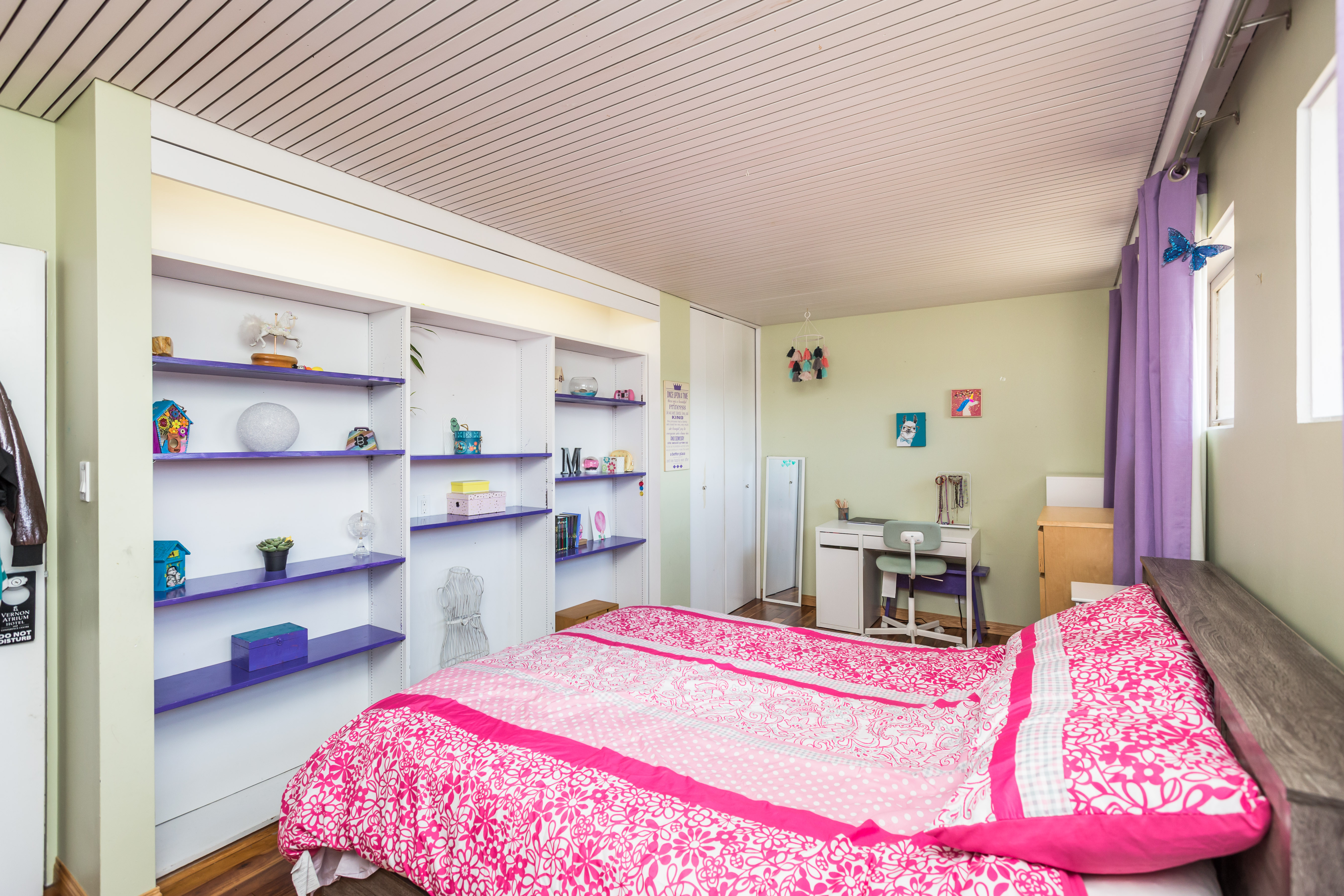 a bedroom with a pink blanket