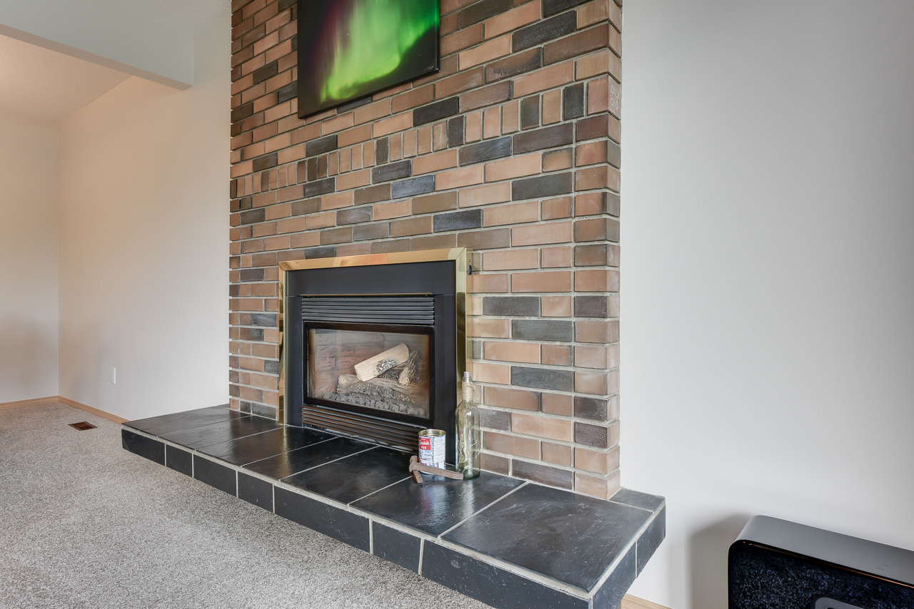 a fire place sitting in a living room with a television and a fireplace