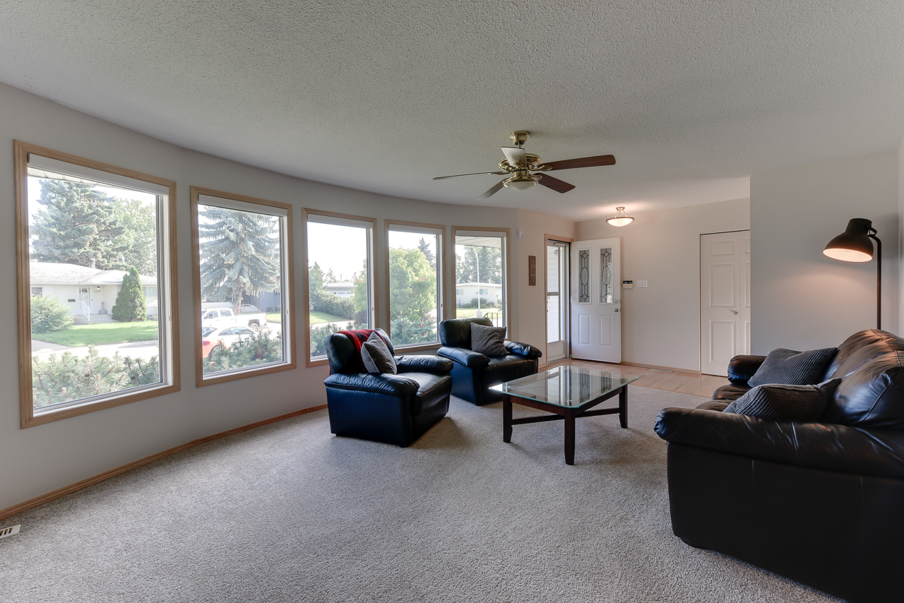 a living room filled with furniture and a large window