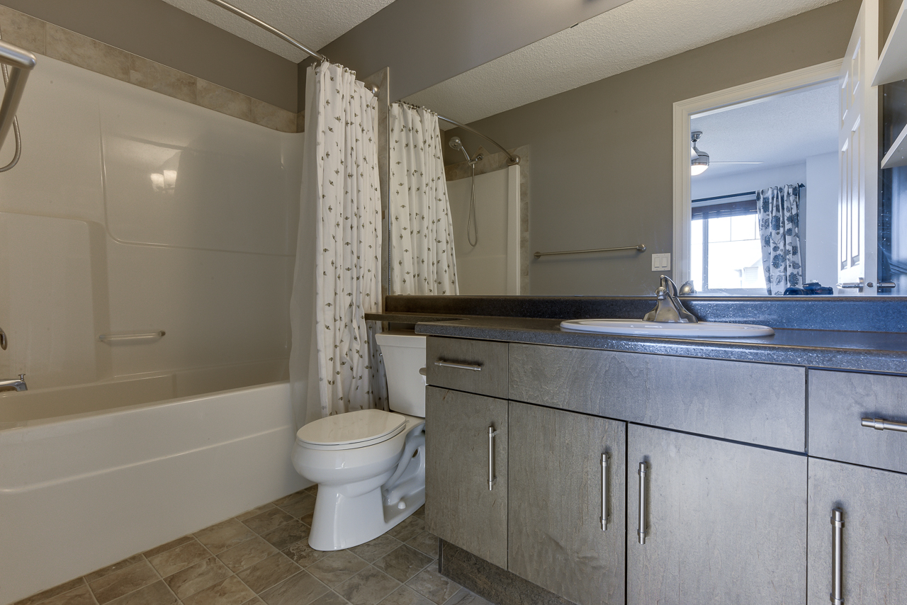 a kitchen with a sink and a mirror