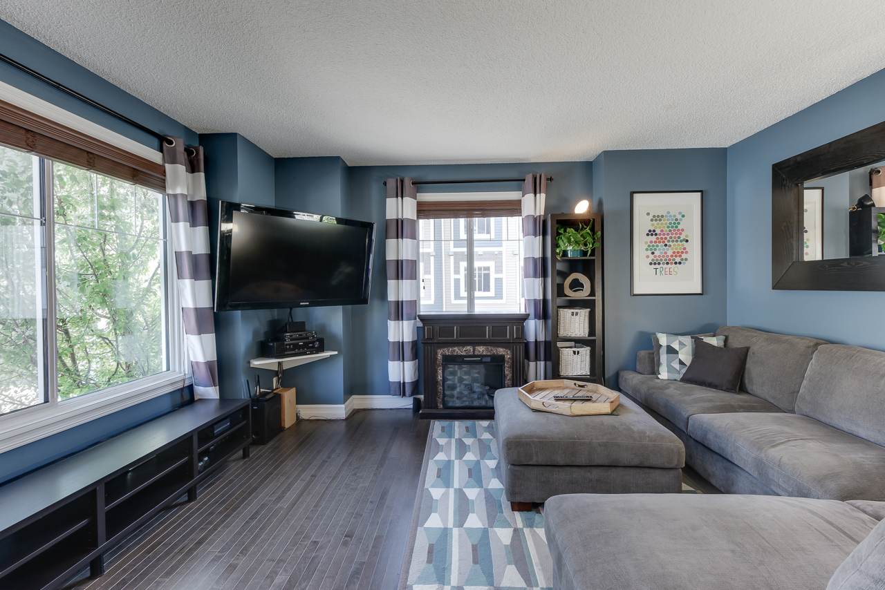 a living room filled with furniture and a large window