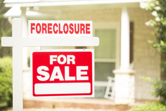 home in the with a foreclosure sign