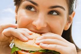 Lady eating a  hamburger