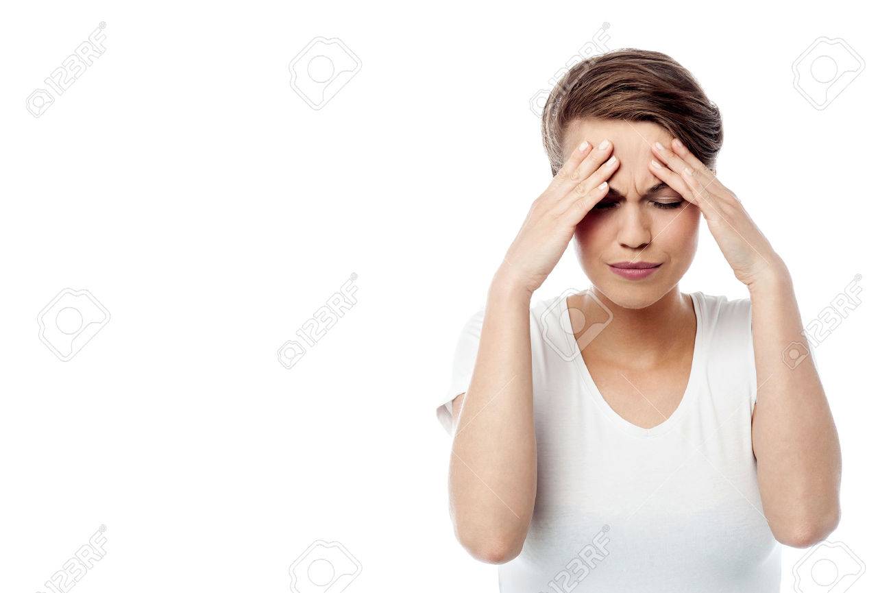 Frustrated woman in a white shirt with hands on her head