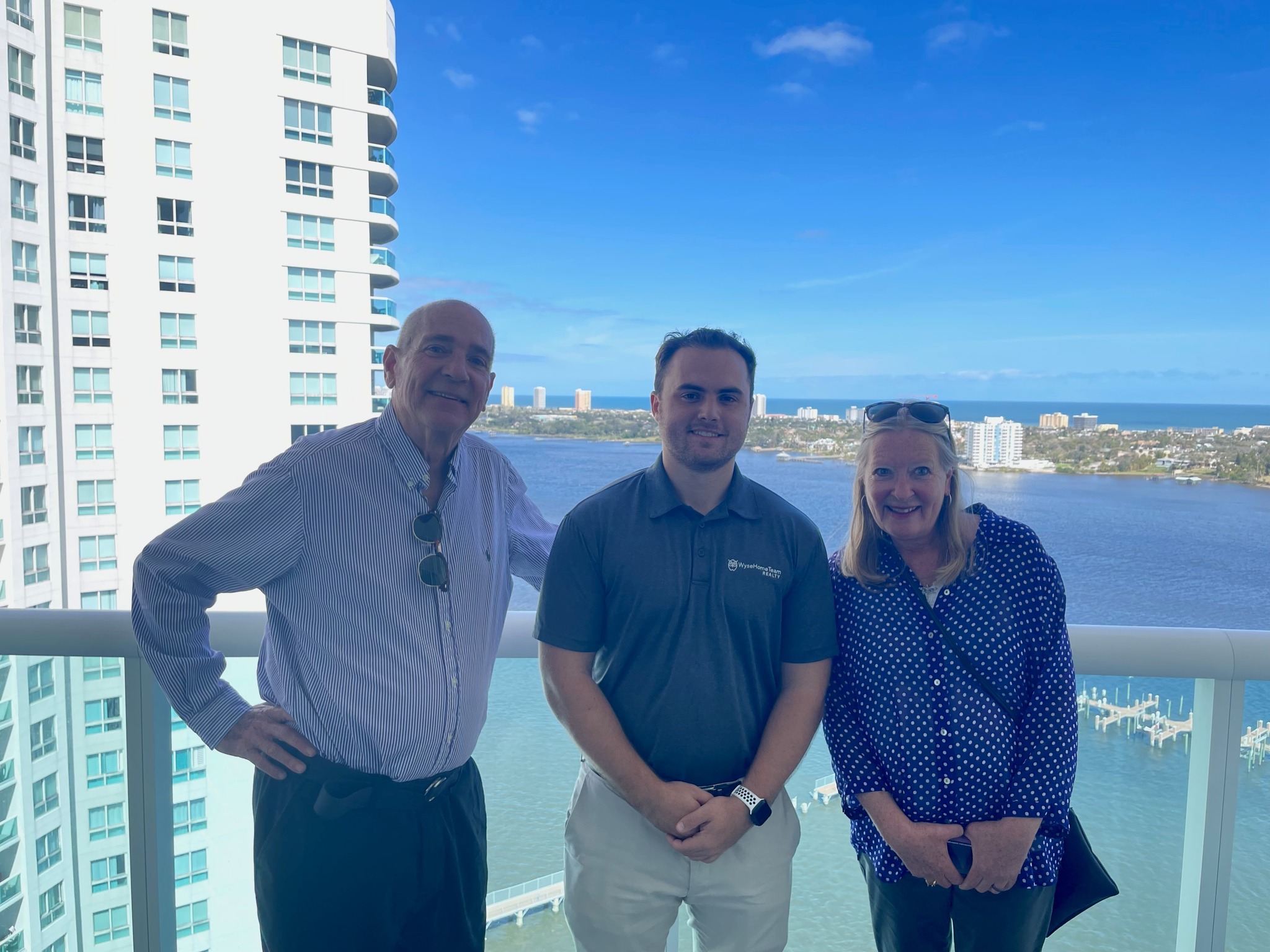 MATT WITH HIS CLIENTS ON THEIR NEW CONDO BALCONY