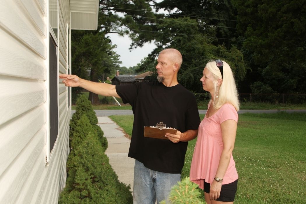 image of a couple inspecting the house for the final walkthrough