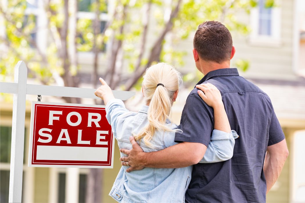 image of a couple buying a house that's for sale