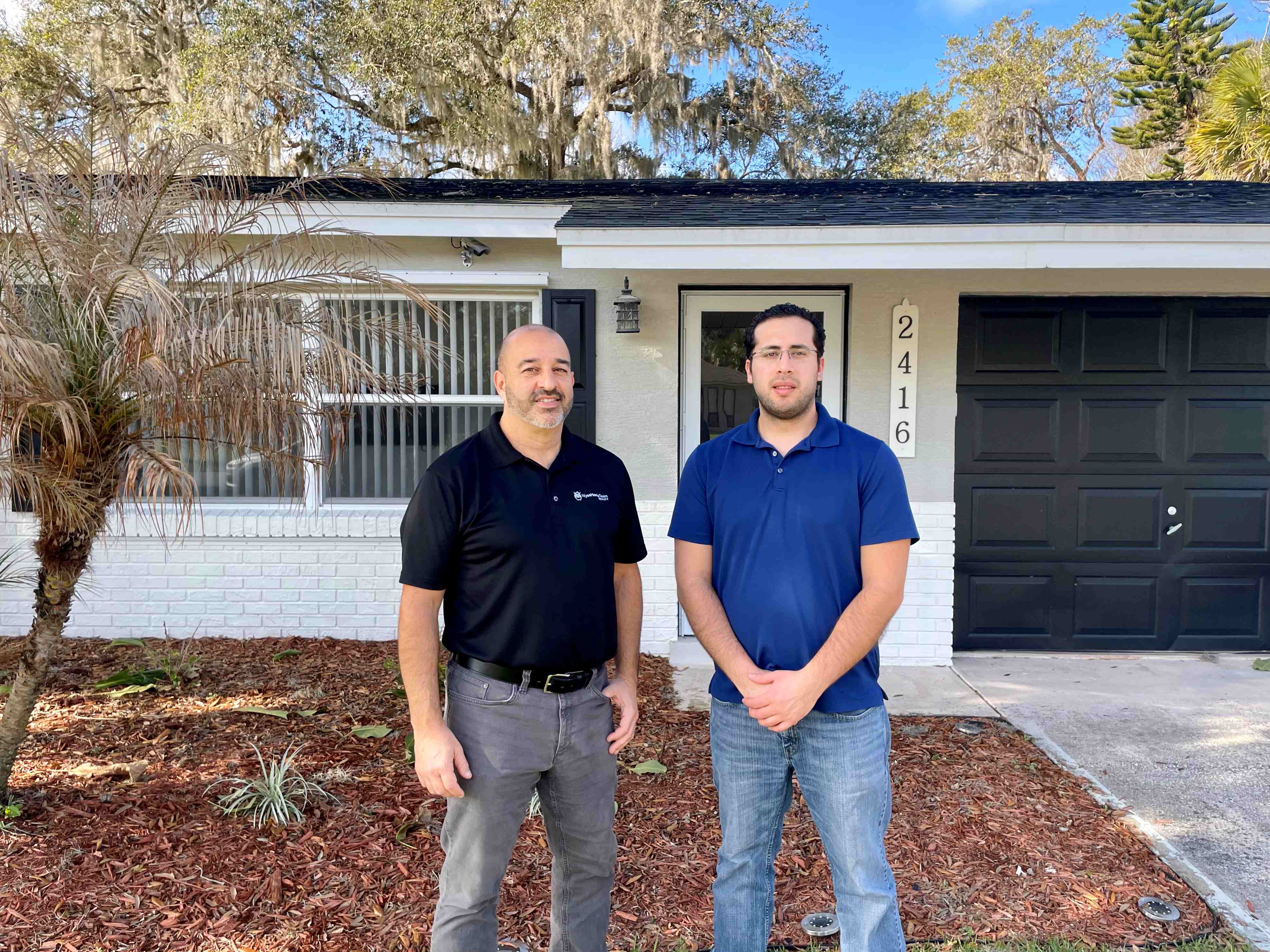 Ron and his client in front of their new home