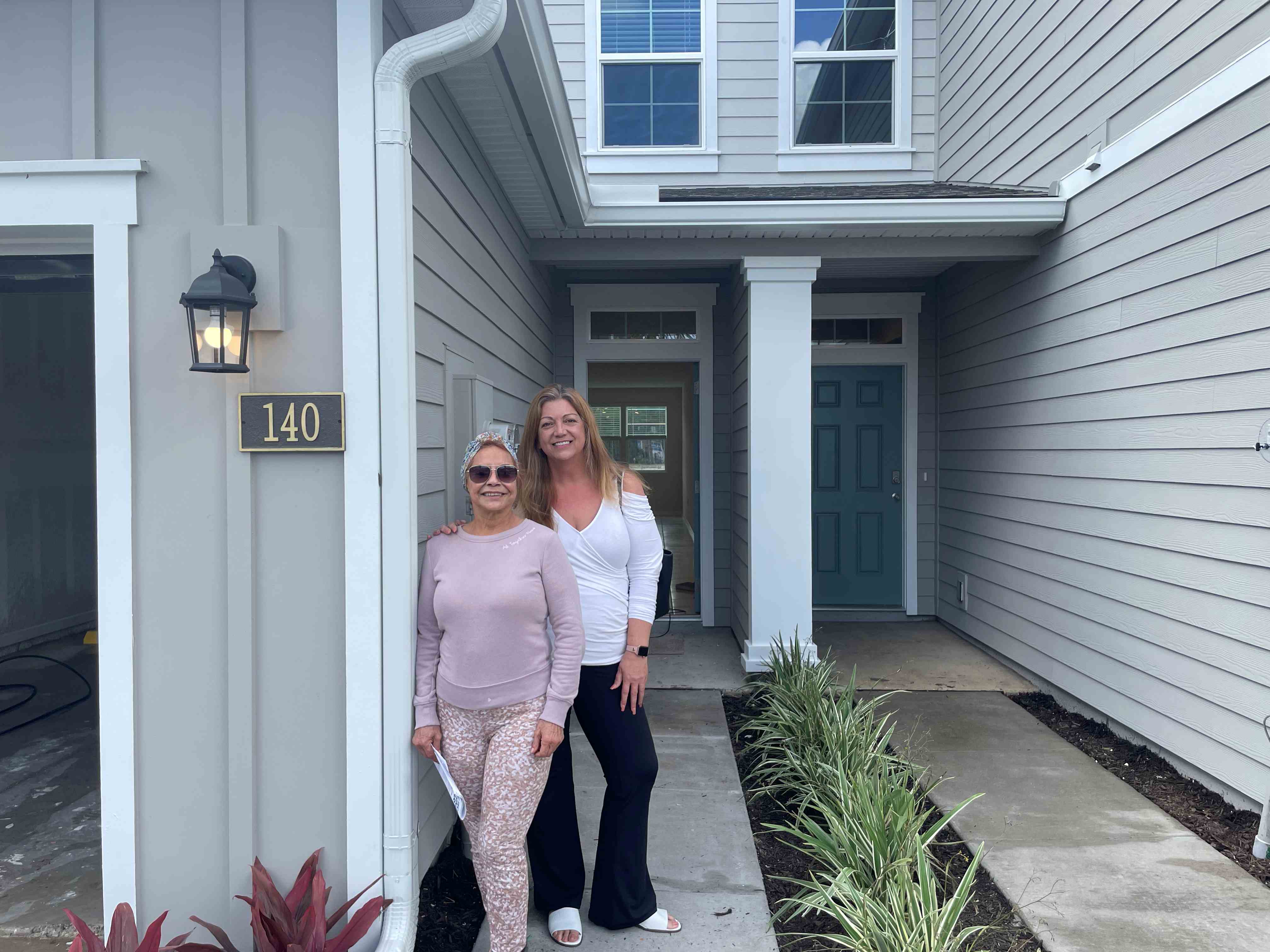 Suzanne with her client outside a brand new townhome