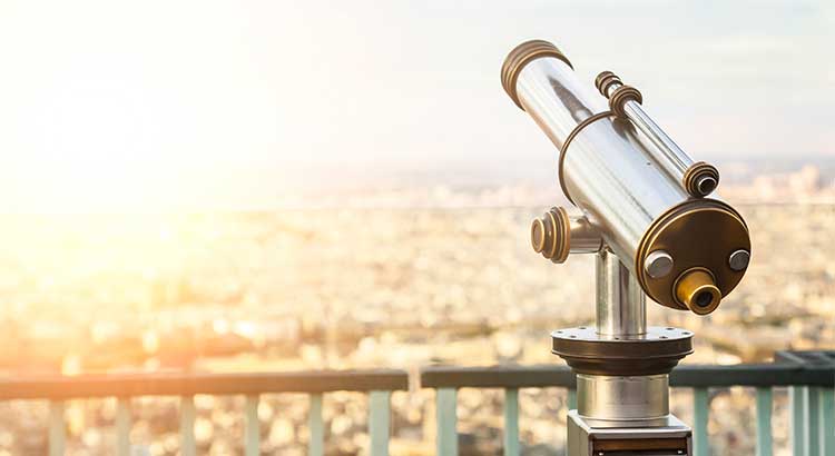 telescope with cityscape in background