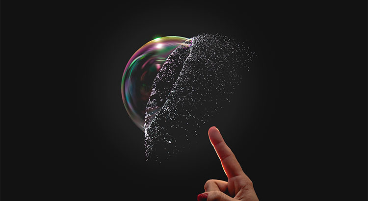 finger pointing up to burst a bubble against a black background