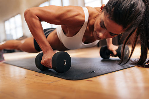 woman pressing weights in a gym