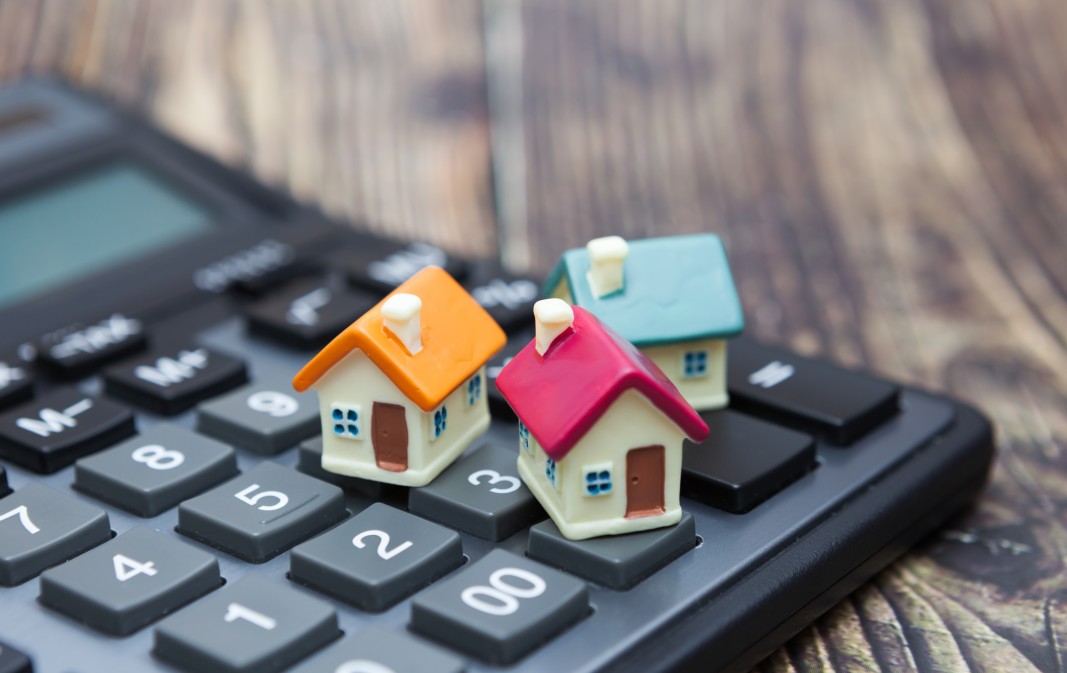 Miniature models of charleston homes on a calculator