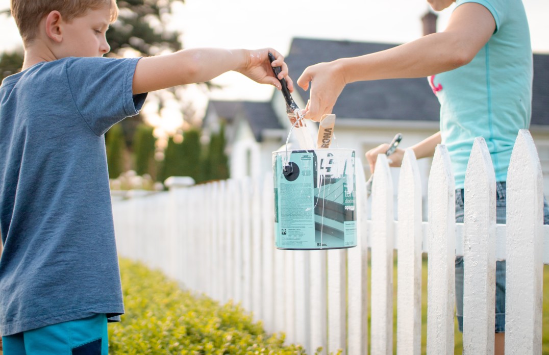 Kids painting a white picket fence in charleston south Carolina