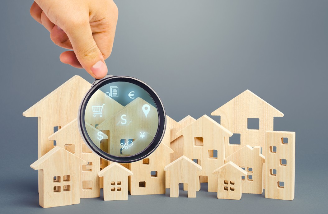 Hand with Magnifying Glass searching model wood block Charleston homes for sale