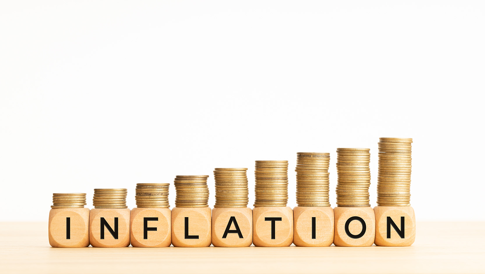 Inflation Sign in front of Stacks of Coins