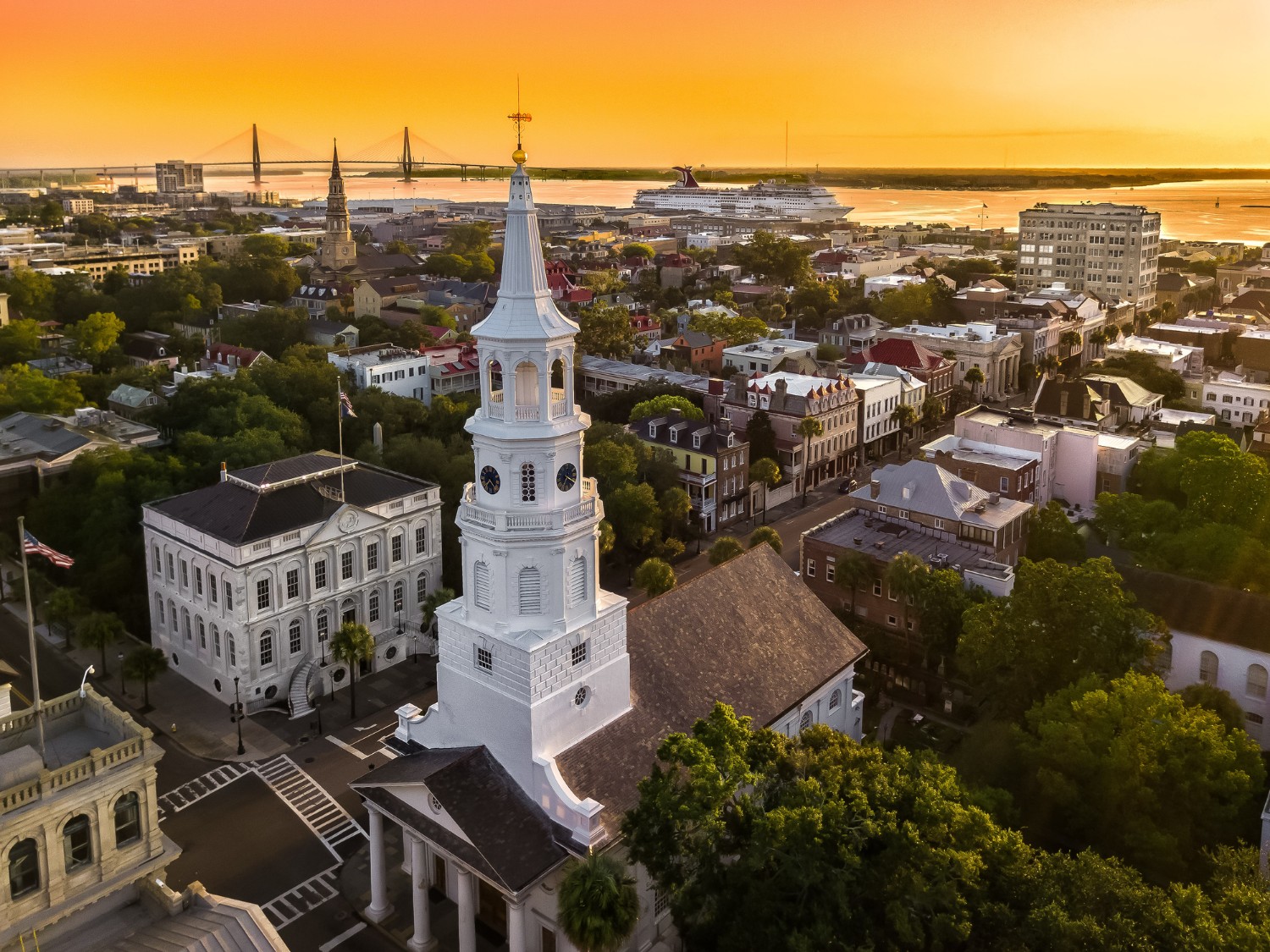 View of Downtown Charleston homes at Sunset with Ravenel Bridge and Cruise Ship in back