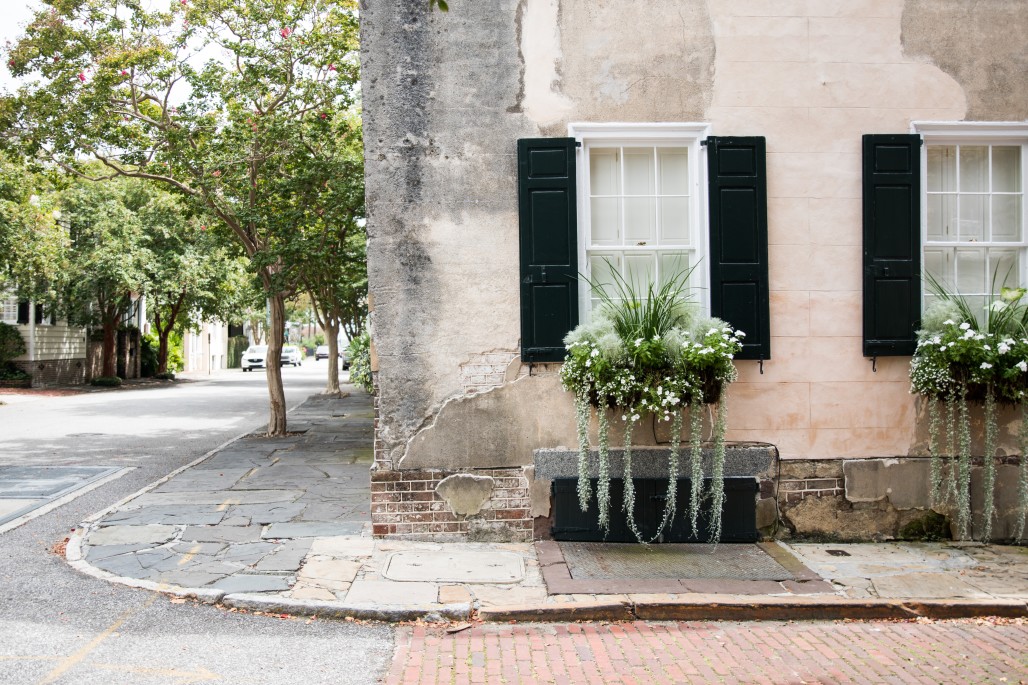 historic charleston, sc home with window box and cobble stone street