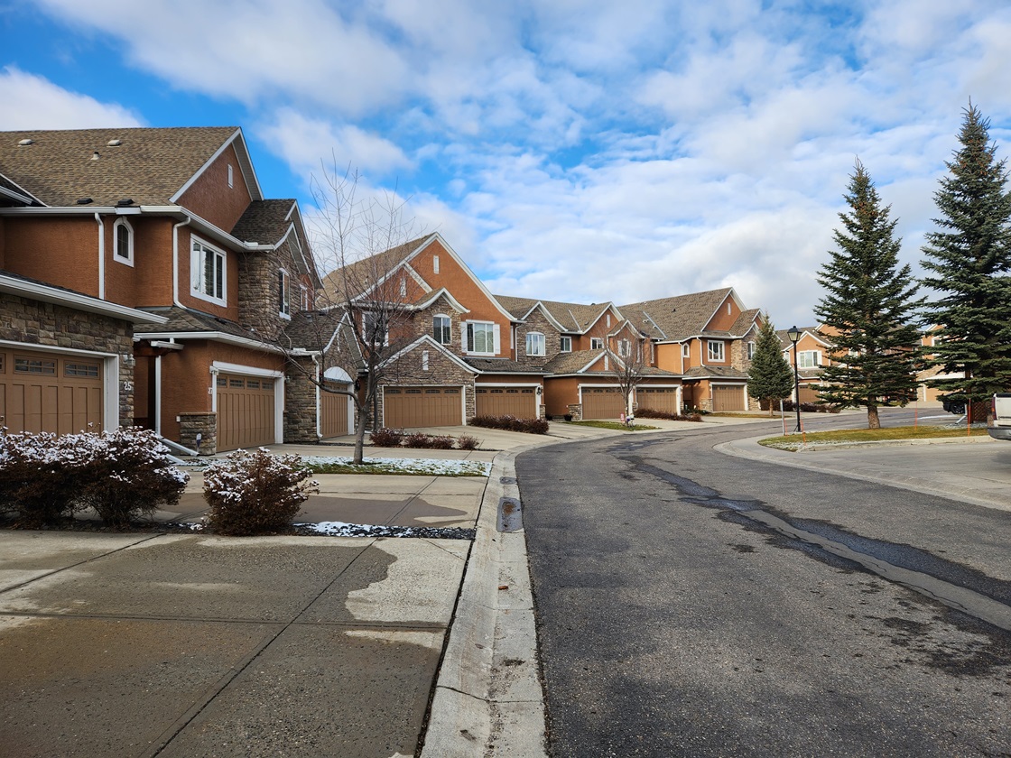 Row of two storey townhomes with front attached garages
