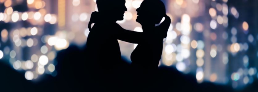 Two silhouettes hugging 