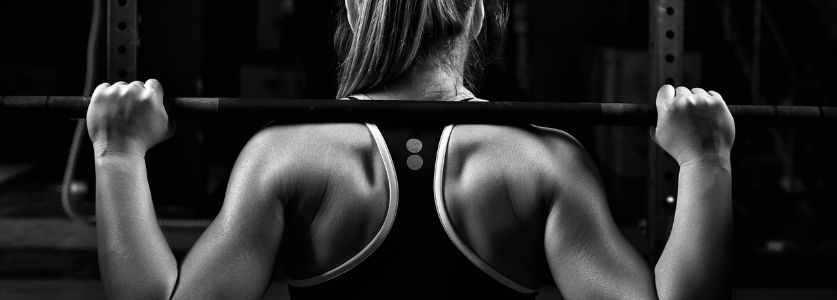 woman with barbell on back