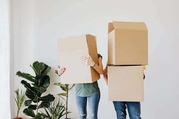 Renters carrying moving boxes
