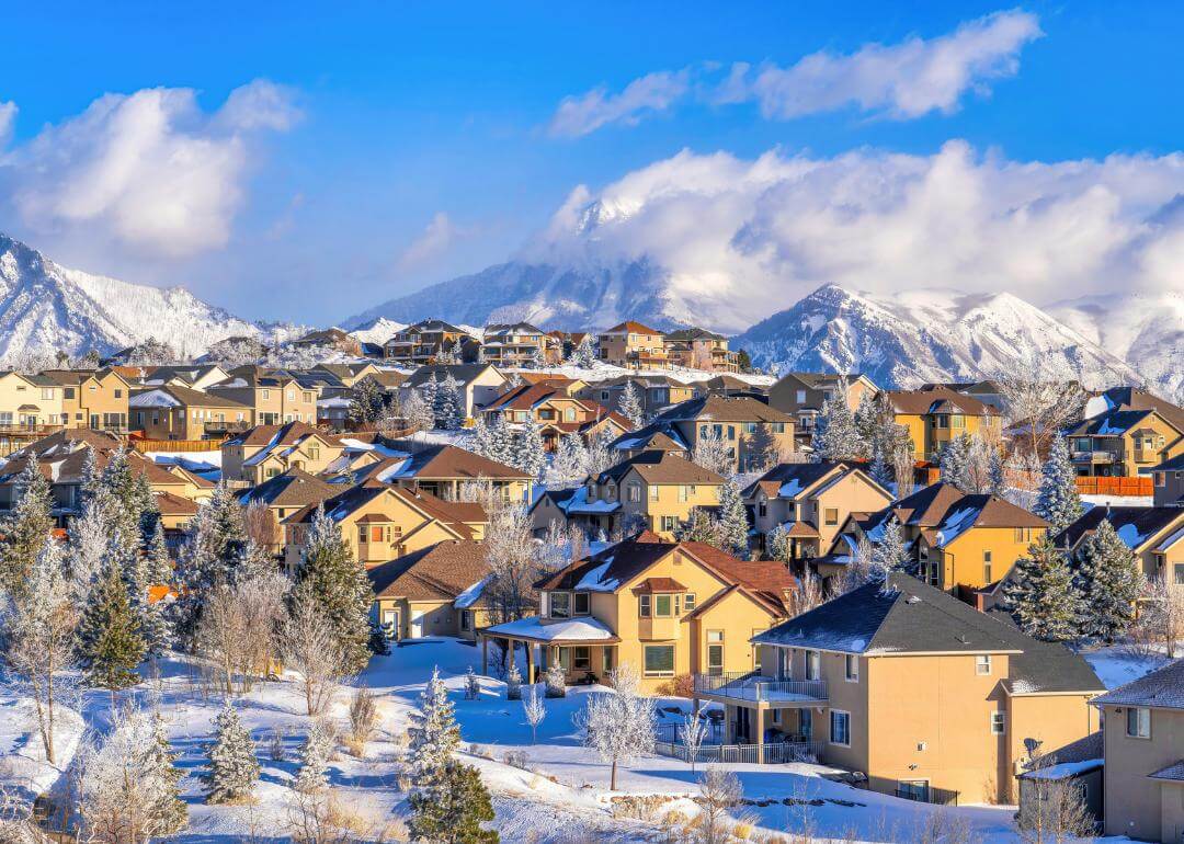 A photo of a neighborhood in Utah with mountains and snow