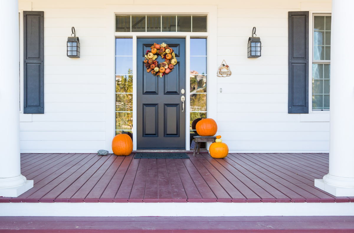 Fall front door with wreath and pumpkins