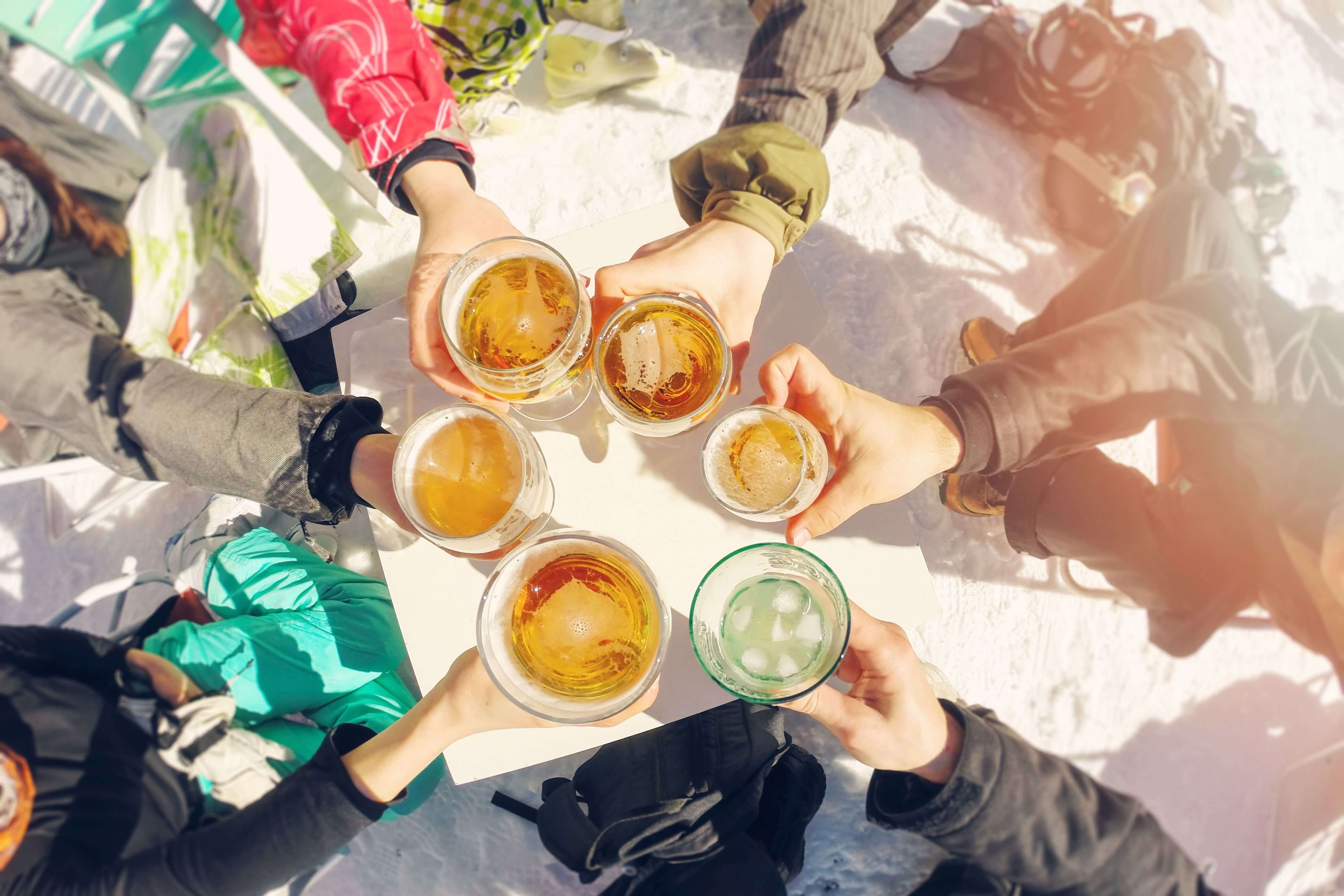 Group of skiiers with beers.