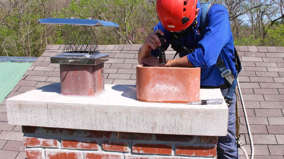 A professional inspecting a chimney