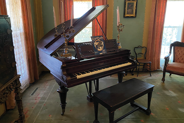 Photo of the piano inside the sitting room in the Overholser Mansion