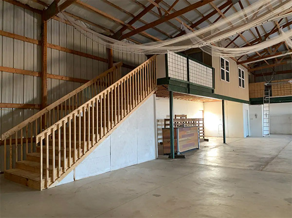 interior of the barn, showing the steps leading up to the loft/living area