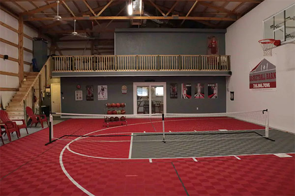 Indoor basketball court inside of a converted airbnb barn