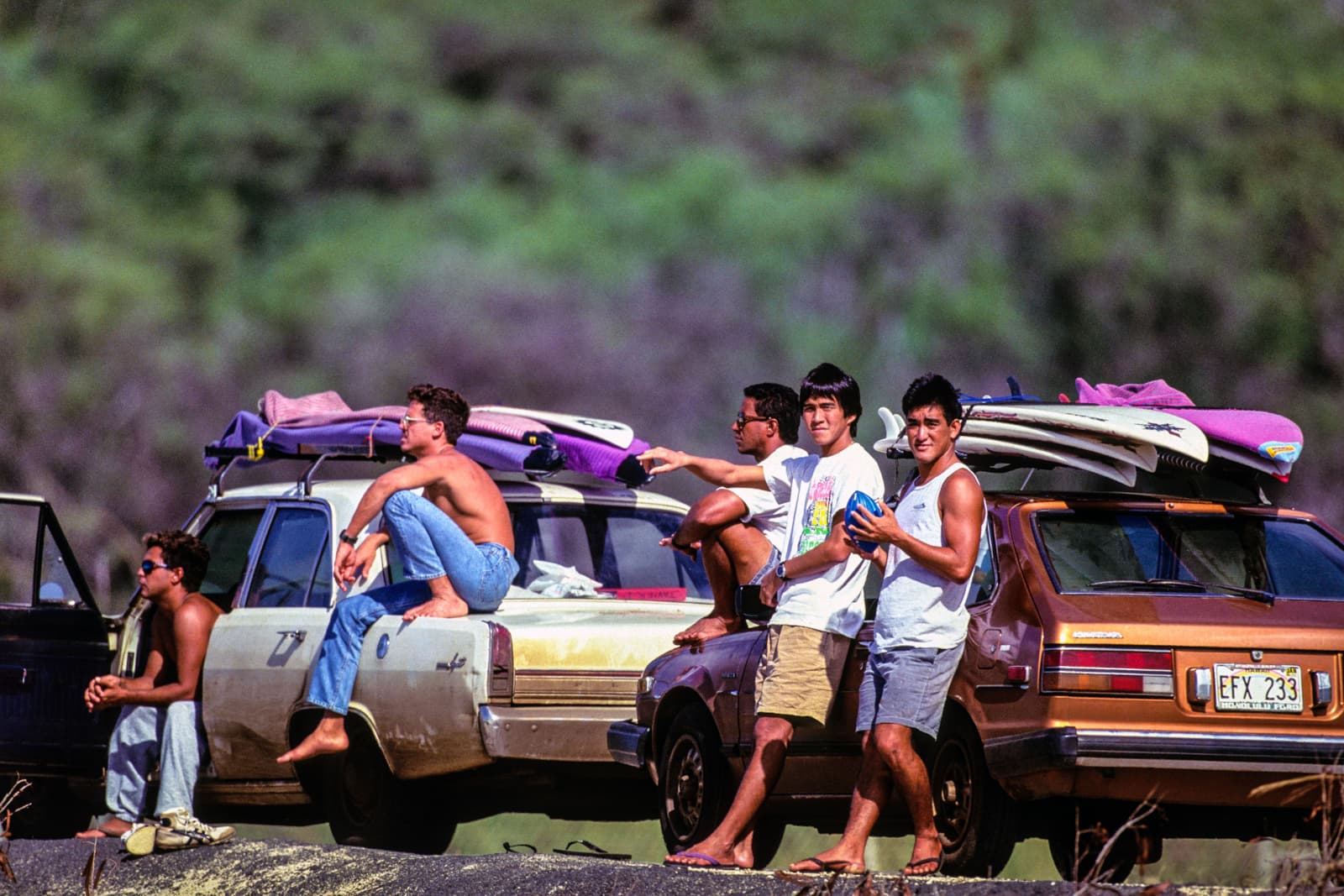 Guys resting on cars