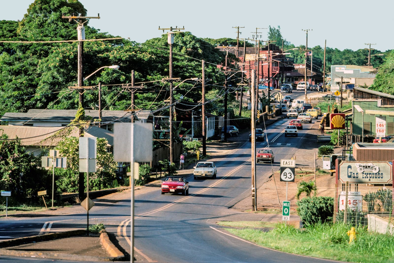 Cars driving down a hill in Hawaii