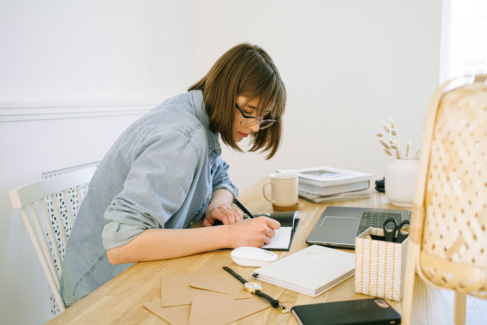Woman working at a desk in what appears to be a home