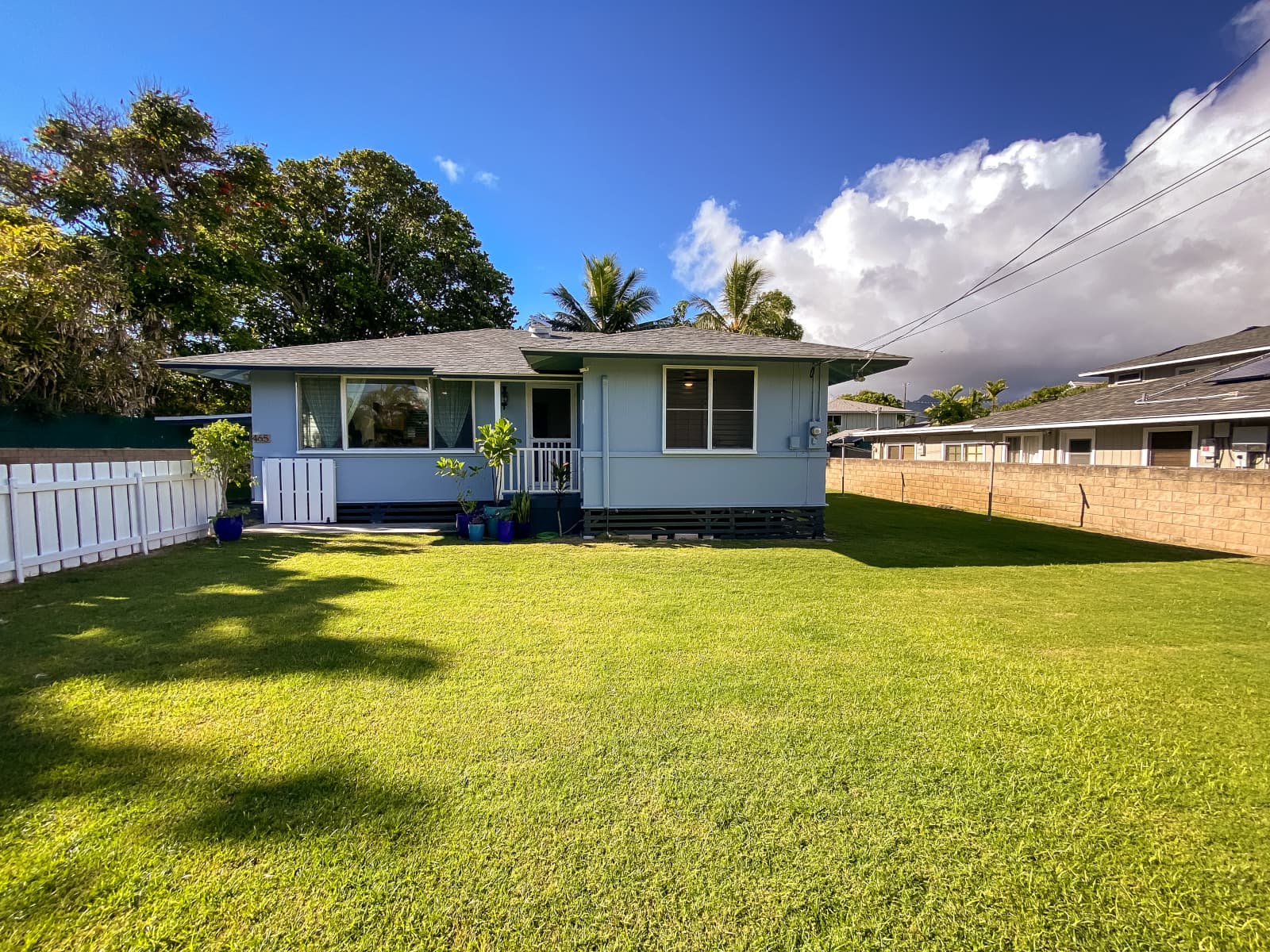 Hawaii Home with green grass lawn