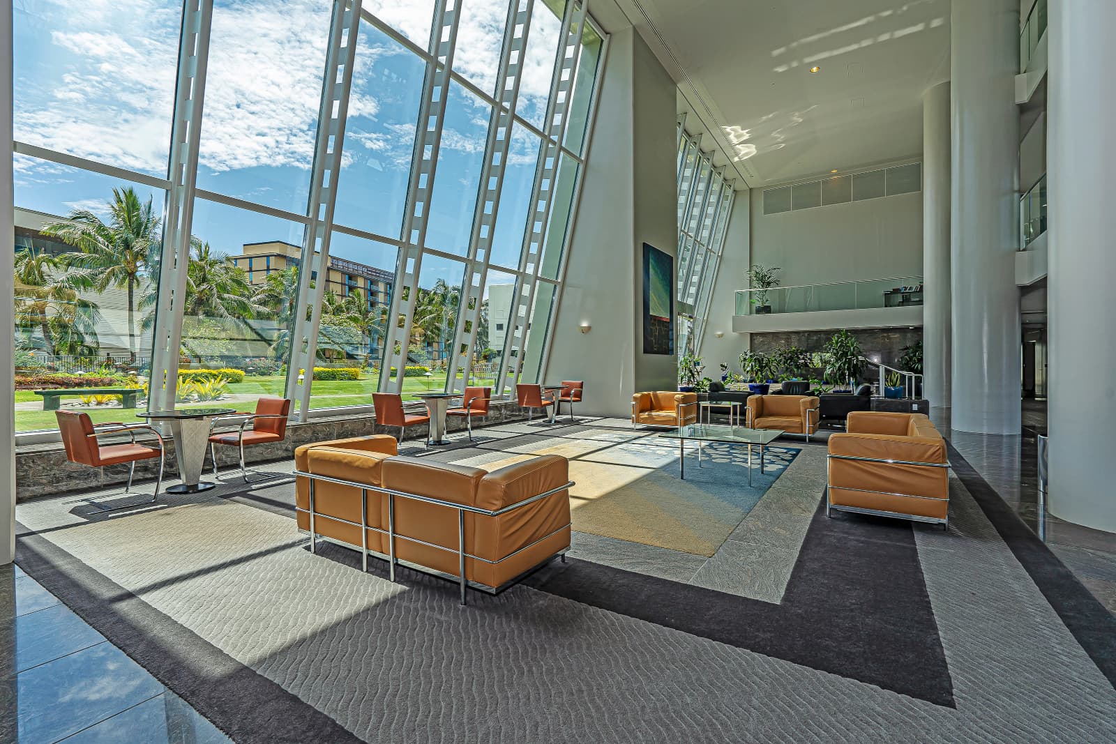 Community area in Hawaiki Tower with large glass windows overlooking a lawn