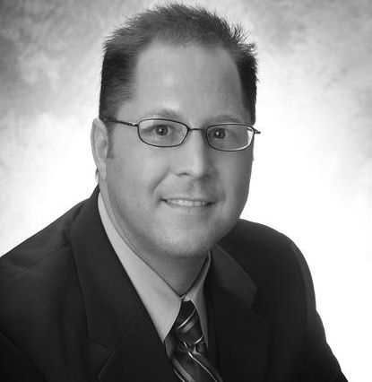 Black and whit headshot of Brain Burk from Kenna Real Estate